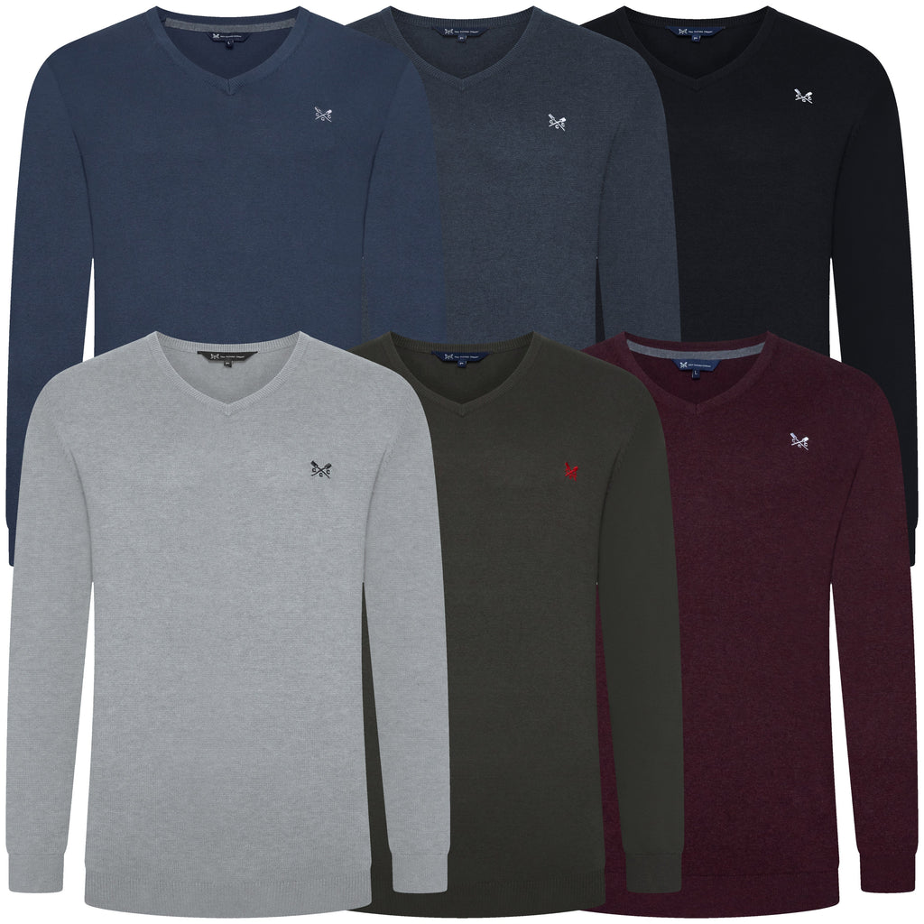 Collection of six V-neck sweaters in various colors on a white background