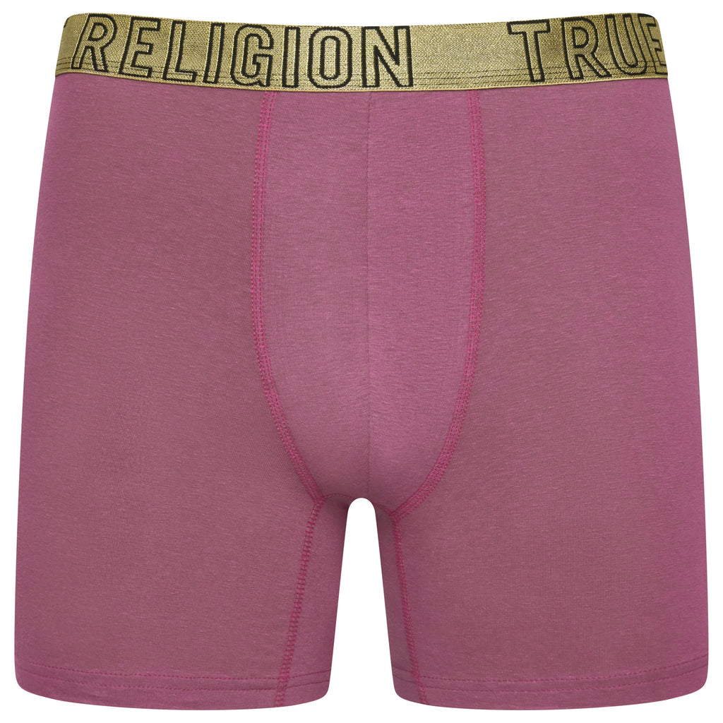 Pink boxer briefs with a gold 'RELIGION' waistband on a white background